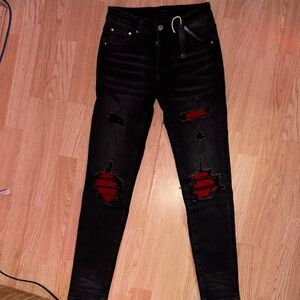 AMIRI Black Skinny Jeans with Red Underlay